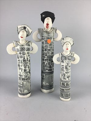 Lot 351 - A SET OF THREE PAINTED POTTERY FIGURES OF STYLISED FEMALES