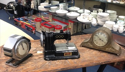 Lot 459 - A VINTAGE TINPLATE SEWING MACHINE AND TWO MINIATURE MANTEL CLOCKS