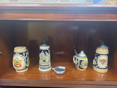 Lot 513 - A HIP FLASK AND FOUR GERMAN CERAMIC TANKARDS