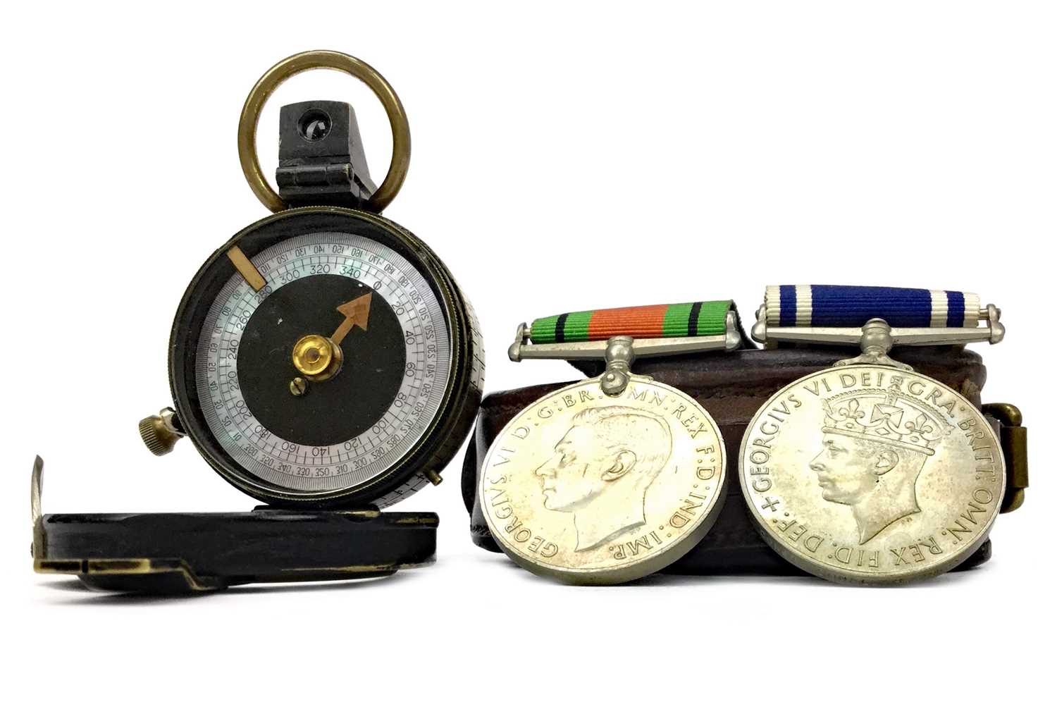 Lot 1141 - A WWI PRISMATIC COMPASS, POLICE LONG SERVICE MEDAL AND A DEFENCE MEDAL