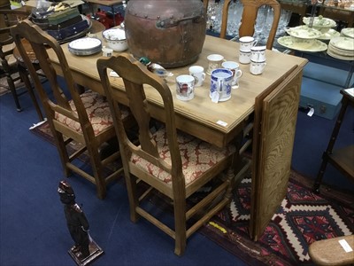 Lot 333 - A PINE EXTENDING DINING TABLE AND FOUR CHAIRS