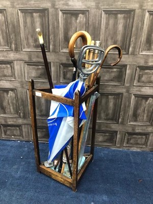 Lot 194 - AN OAK STICK STAND, WITH STICKS AND UMBRELLAS