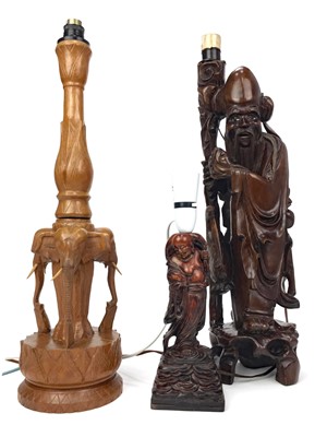 Lot 804 - A CHINESE CARVED IRONWOOD FIGURAL LAMP AND TWO OTHERS