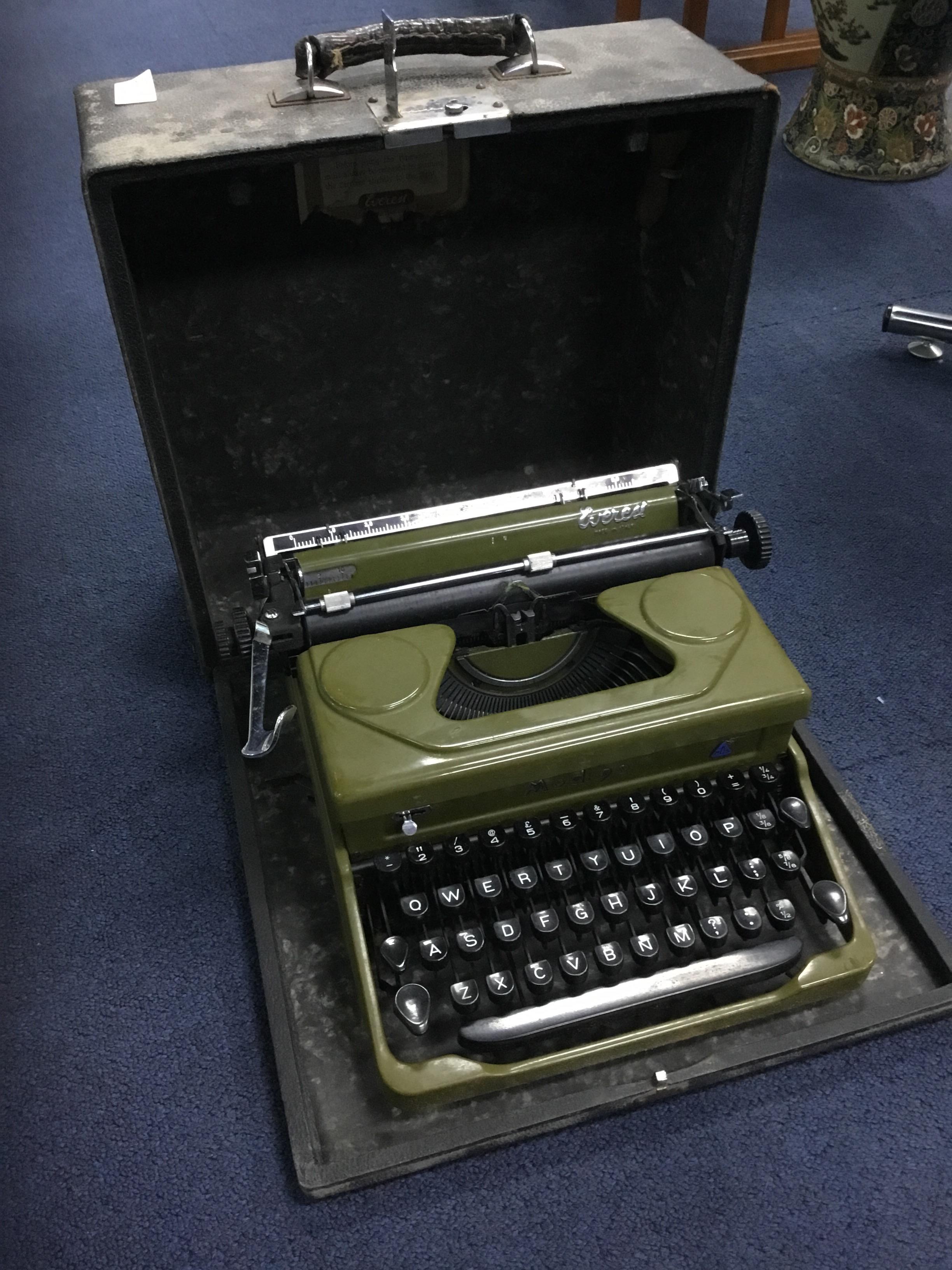 Lot 100 A VINTAGE TYPEWRITER AND A CASED TAPE