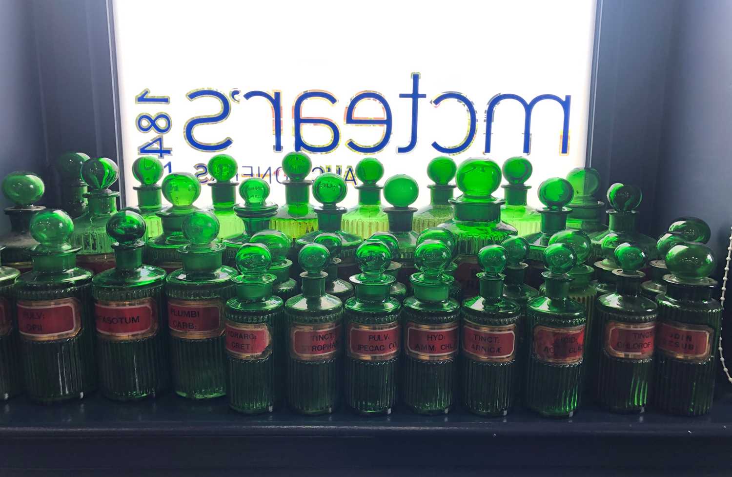 Lot 1058 - A LOT OF EARLY 20TH CENTURY GREEN GLASS PHARMACEUTICAL BOTTLES