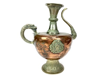 Lot 872 - A TIBETAN COPPER AND WHITE METAL MOUNTED EWER