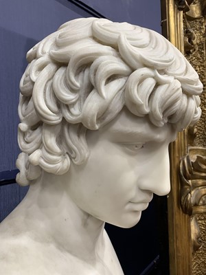Lot 1204 - A 19TH CENTURY CARRARA MARBLE BUST OF ANTINOUS