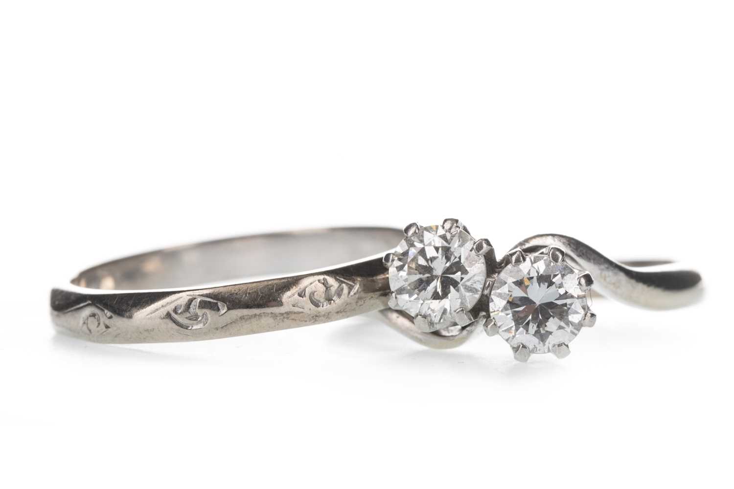 Lot 429 - A DIAMOND TWO STONE RING AND A WEDDING BAND