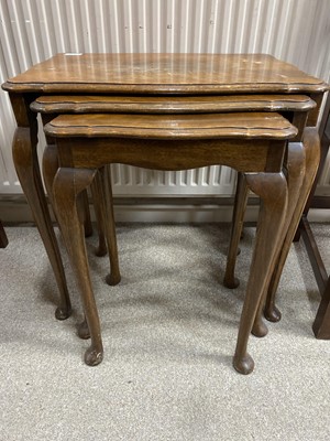 Lot 265 - A NEST OF THREE STAINED WOOD TABLES