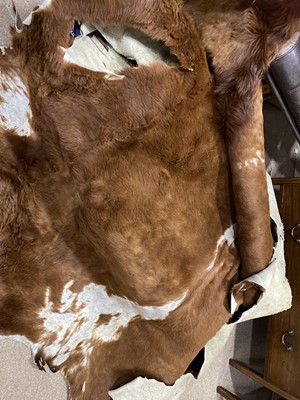 Lot 119 - A LARGE COW HIDE RUG