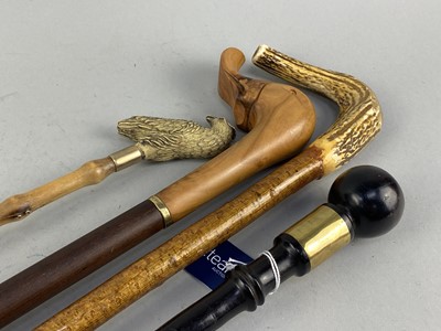 Lot 339 - AN EBONY WALKING CANE, TWO WALKING STICKS AND A SHOE HORN