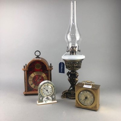 Lot 231 - A REPRODUCTION CAST BRASS OIL LAMP AND THREE CLOCKS
