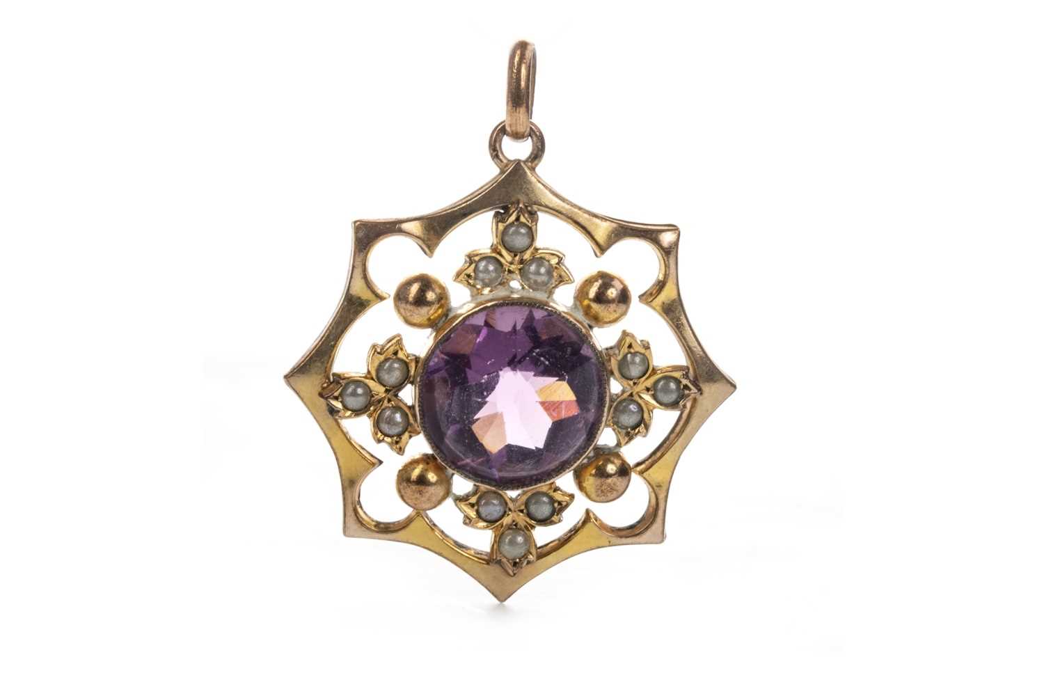 Lot 929 - A PURPLE GEM SET AND SEED PEARL PENDANT