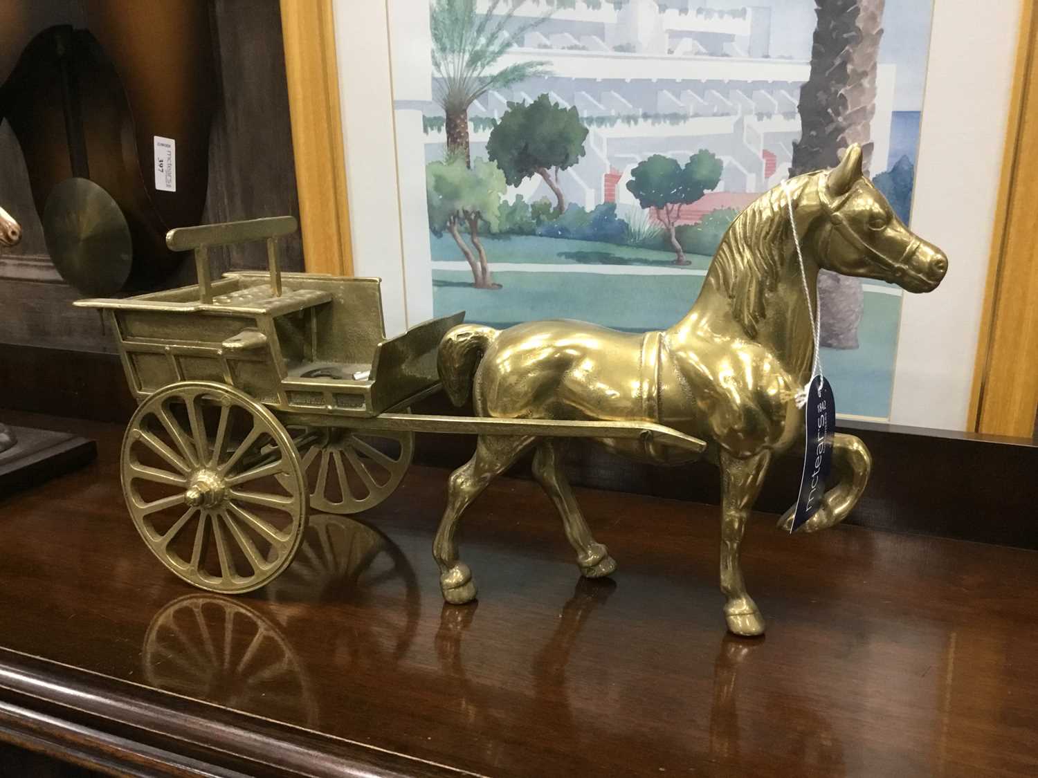 Lot 370 - A PAIR OF BRASS HORSE DRAWN CARTS AND A CERAMIC MODEL OF A HORSE