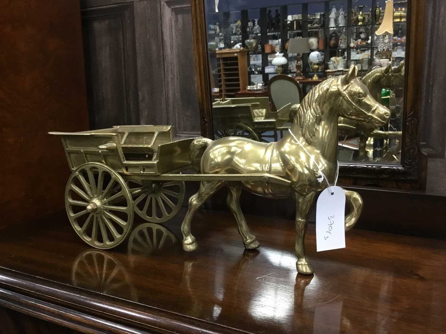 Lot 370 A PAIR OF BRASS HORSE DRAWN CARTS AND A