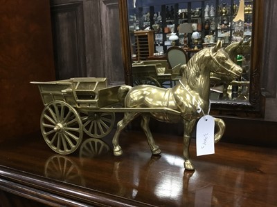 Lot 370 - A PAIR OF BRASS HORSE DRAWN CARTS AND A CERAMIC MODEL OF A HORSE