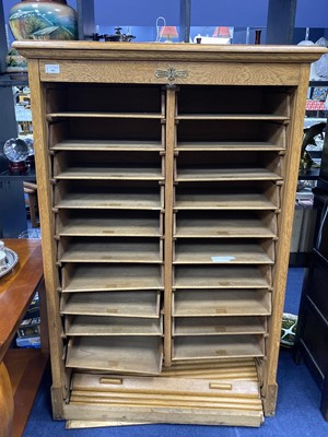 Lot 483 - AN EARLY 20TH CENTURY OAK SHUTTER FRONT MUSIC CABINET