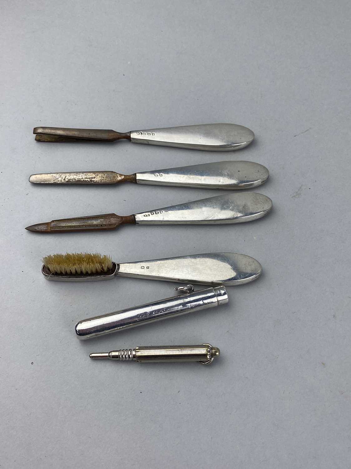 Lot 19 - A SILVER HANDLED FOUR PIECE MANICURE SET, PENCIL AND SILVER PENCIL CASING