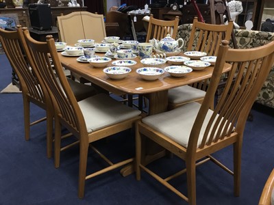 Lot 221 - AN ERCOL OAK DINING TABLE AND SIX CHAIRS