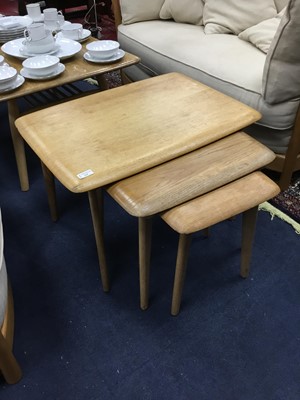 Lot 225 - AN ERCOL OAK COFFEE TABLE AND NEST OF TABLES