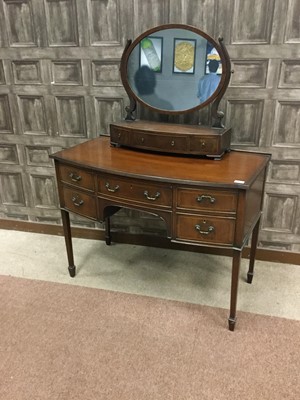 Lot 1632 - A MAHOGANY BOW FRONTED DESK AND A DRESSING MIRROR