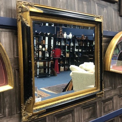 Lot 39 - A WALL MIRROR IN A GILT AND EBONISED FRAME