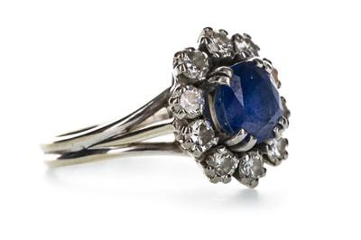 Lot 1331 - A BLUE GEM SET AND DIAMOND CLUSTER RING