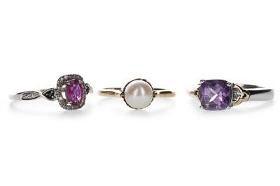 Lot 1361 - A RED GEM SET AND DIAMOND RING, PURPLE GEM SET RING AND A FAUX PEARL RING