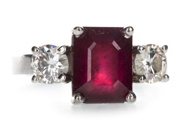 Lot 1391 - A RED GEM SET AND MOISSANITE THREE STONE RING