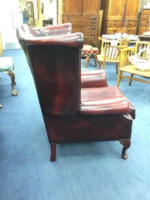 Lot 48 - A WING BACK ARMCHAIR IN OXBLOOD LEATHER