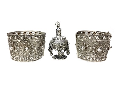 Lot 854 - A PAIR OF INDIAN SILVER CUFFS AND A SPRINKLER/PERFUME BOTTLE