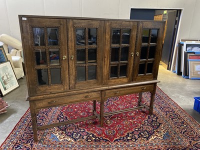 Lot 1711 - AN OAK TWO SECTION BOOKCASE