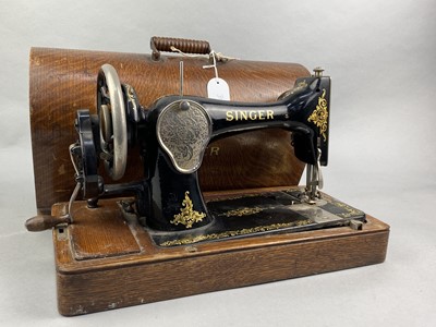 Lot 314 - A SINGER SEWING MACHINE AND A LEATHER SUITCASE