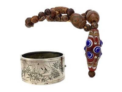 Lot 906 - AN EASTERN GLASS AND COMPOSITION NECKLACE AND A BANGLE