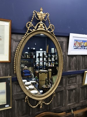 Lot 142 - A REPRODUCTION OVAL WALL MIRROR