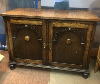 Lot 590 - A 20TH CENTURY OAK TWO DOOR CABINET