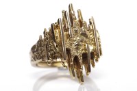 Lot 10 - 1970S NINE CARAT GOLD RING the bezel formed by...