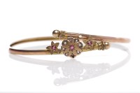 Lot 30 - VICTORIAN RUBY AND SEED PEARL BANGLE of floral...