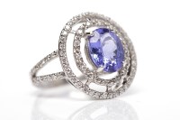 Lot 49 - TANZANITE AND DIAMOND RING the central oval...