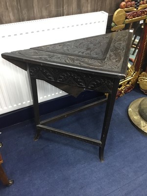 Lot 466 - A CARVED OAK TRIANGULAR DROP LEAF TABLE