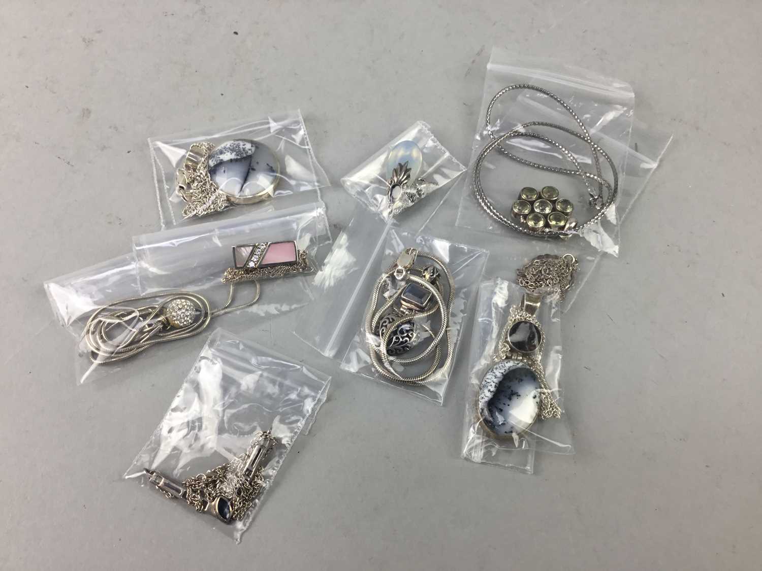 Lot 25 - A COLLECTION OF NINE SILVER PENDANTS AND CHAINS