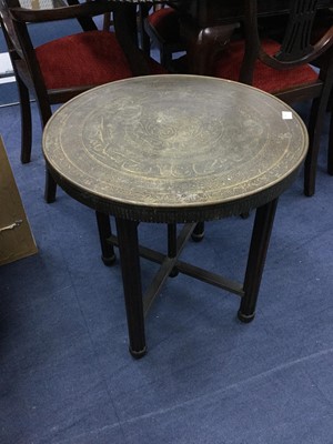 Lot 338 - AN EASTERN BRASS CIRCULAR TABLE WITH FOLDING WOODEN SUPPORTS