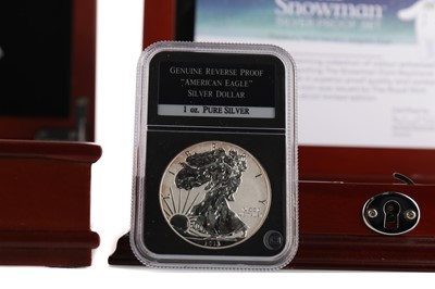 Lot 18 - THE AMERICAN EAGLE SILVER DOLLARS COIN COLLECTION AND THE SNOWMAN FIFTY PENCE SILVER COIN SET