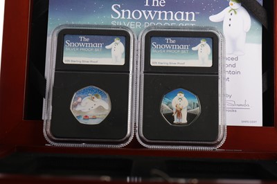 Lot 18 - THE AMERICAN EAGLE SILVER DOLLARS COIN COLLECTION AND THE SNOWMAN FIFTY PENCE SILVER COIN SET