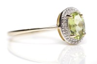 Lot 145 - PERIDOT AND DIAMOND DRESS RING the central...
