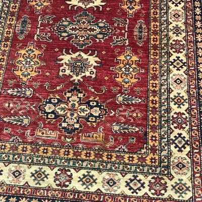 Lot 556 - A KAZAK RUG