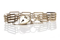 Lot 183 - NINE CARAT GOLD GATELINK BRACELET with a heart...