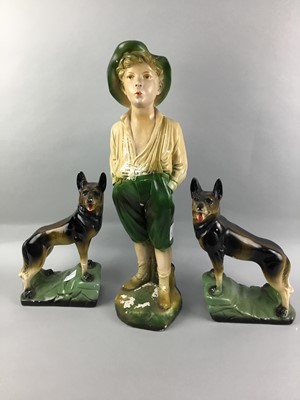 Lot 145 - A PAINTED STUCCO FIGURE OF THE WHISTLING BOY ALONG WITH TWO ALSATIANS