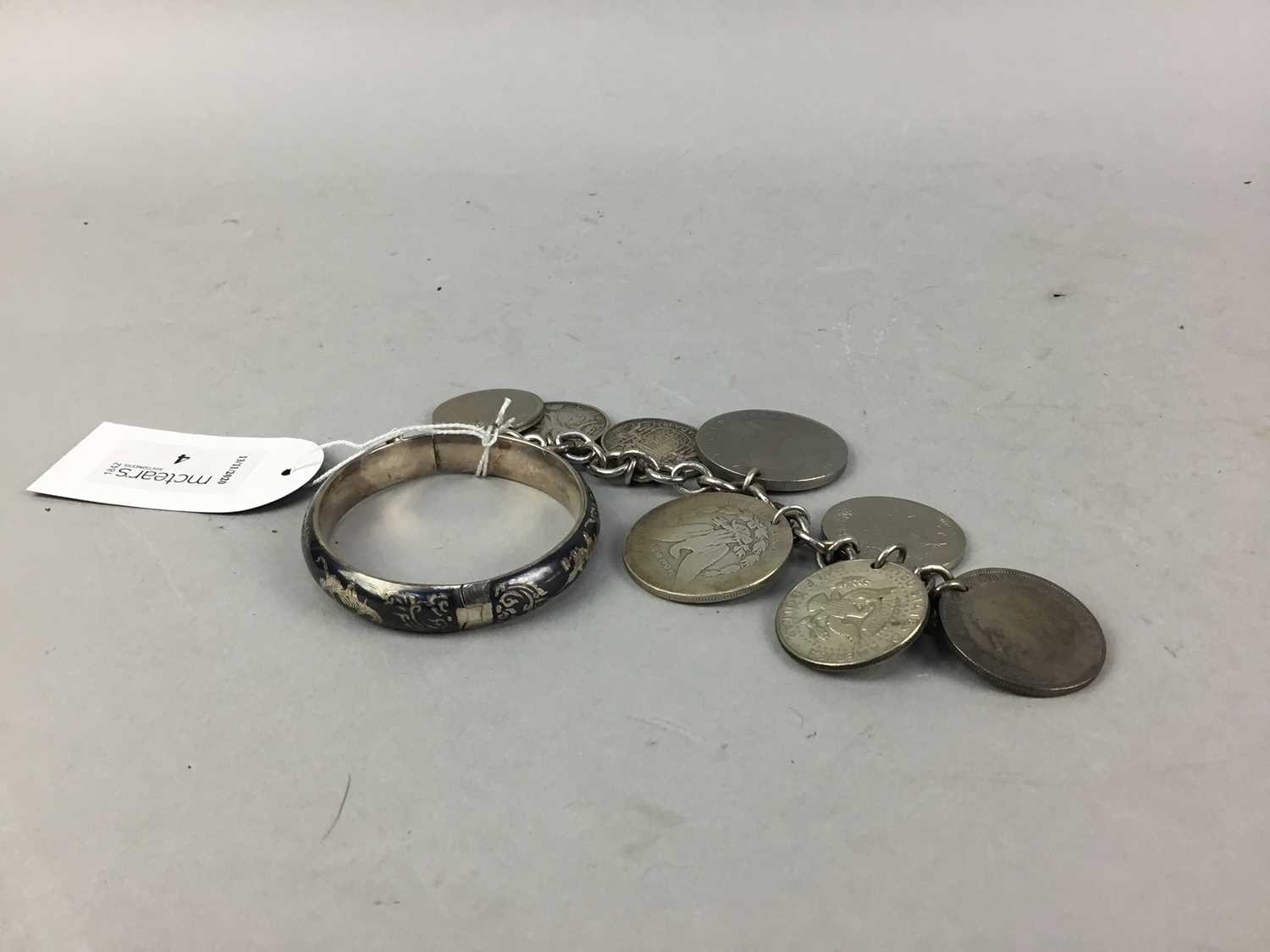 Lot 4 - A SILVER BANGLE AND COIN BRACELET