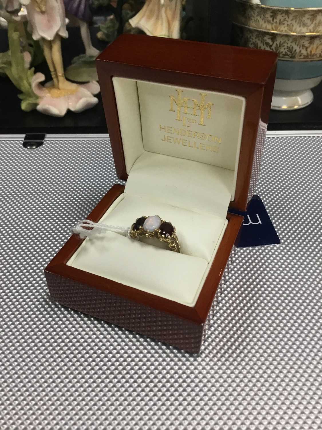 Lot 1 - A GOLD OPAL AND GARNET THREE STONE RING